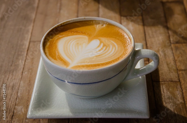 Obraz cup of cappucchino over wooden table