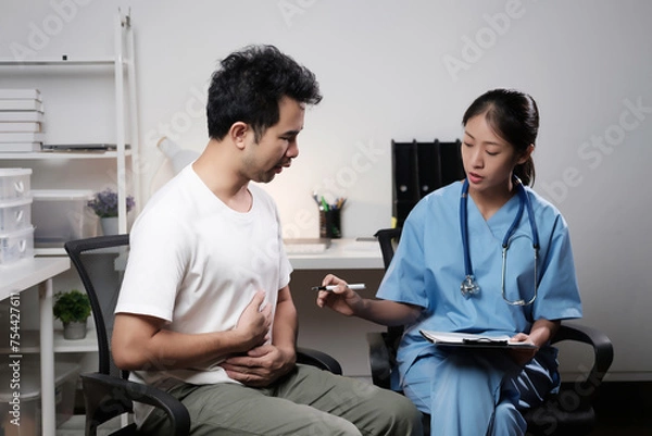 Obraz A man is sitting in a chair with a woman doctor looking at him