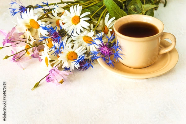 Fototapeta happy mother's day concept, cup of coffee and bunch of wildflowers on a white paint wooden background, copy space