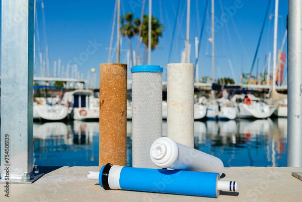 Obraz A set of used cartridges for water purification. Filters and membranes for the reverse osmosis system on the yacht