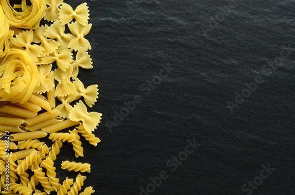 Obraz Differnent types of pasta on a dark background