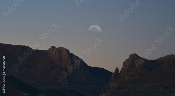 Fototapeta Mountains with the crescent in a double exposure photograph