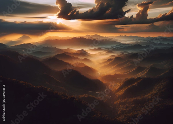 Fototapeta dramatic sunset in the mountains, sky in clouds and light through them
