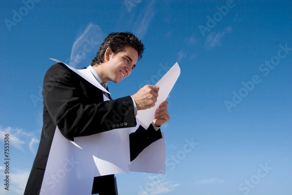 Fototapeta Businessman looking over paperwork
