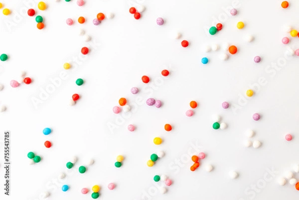 Fototapeta Colorful confectionery sprinkles on white background. Decoration for cake and bakery.