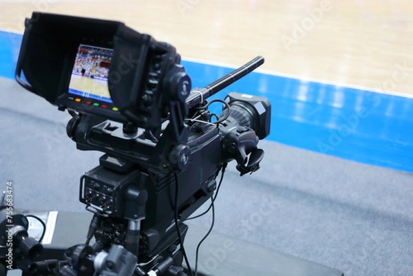 Fototapeta Professional camera with microphone at basketball game in modern stadium