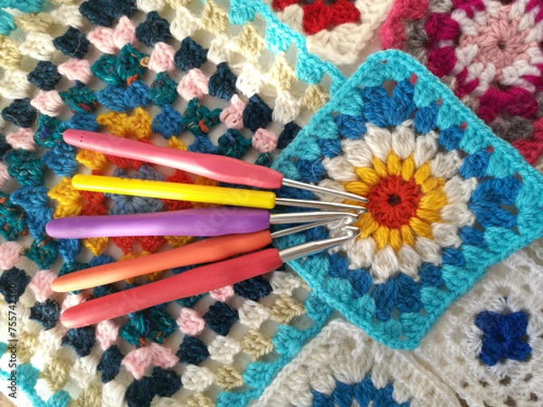 Obraz Crochet hook on a background of threads and a knitted square