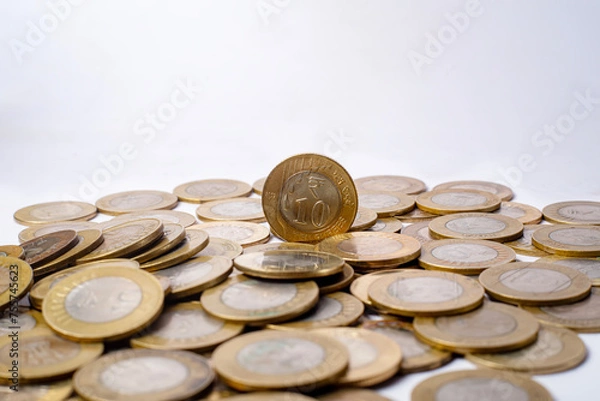 Fototapeta Pile of coins isolated on white background with copy space for text. Indian ten rupees coins