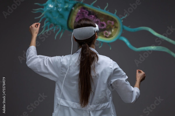 Fototapeta Medical professional uses spatial computier, studying digital model of bacteria