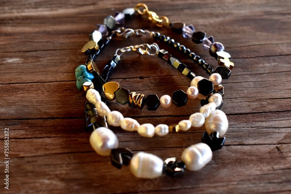 Fototapeta A group of bracelets on a wooden surface