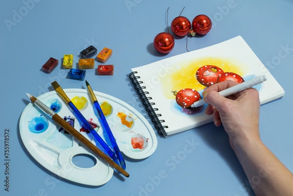 Fototapeta watercolor painting of red balls. Winter watercolor painting with a set of watercolor paints and paintbrushes. Top view