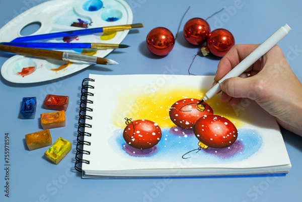 Fototapeta watercolor painting of red balls. Winter watercolor painting with a set of watercolor paints and paintbrushes. Top view