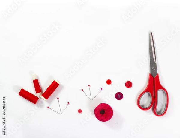 Obraz Red sewing accessories on white background.