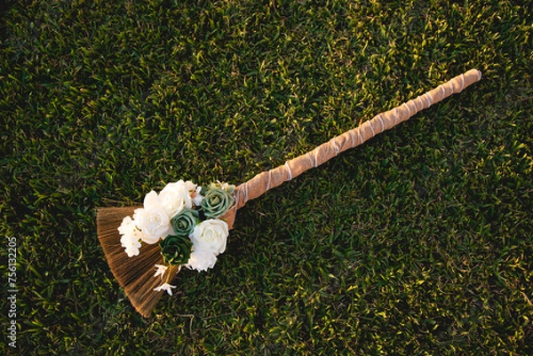 Fototapeta Beautiful traditional broom, Jumping the broom (or jumping the besom) is a phrase and custom relating to a wedding ceremony in which the couple jumps over a broom.