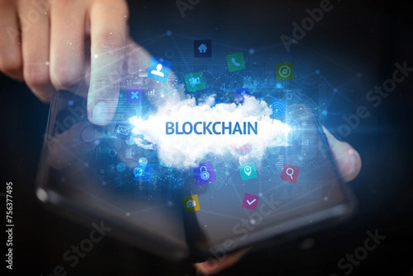 Obraz Businessman holding a foldable smartphone, technology concept