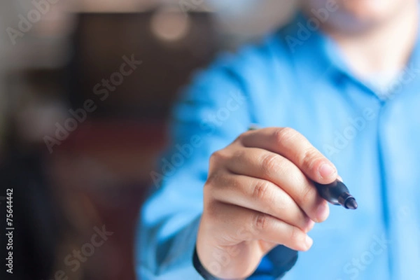 Obraz Young man writing on the chalkboard