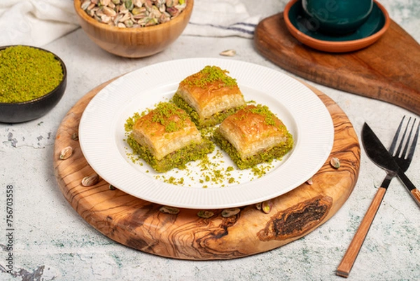 Fototapeta Baklava with pistachios on a wooden background. Turkish cuisine delicacies. Ramadan Dessert. local name kuru baklava