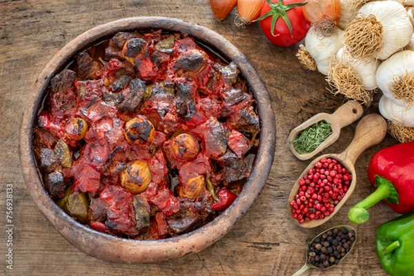Fototapeta Casserole kebab named belen tava or sac saç kebabı . Roasted meat with pepper and tomato. 