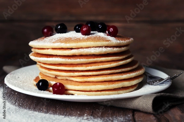 Fototapeta Stack of delicious pancakes with powdered sugar and berries