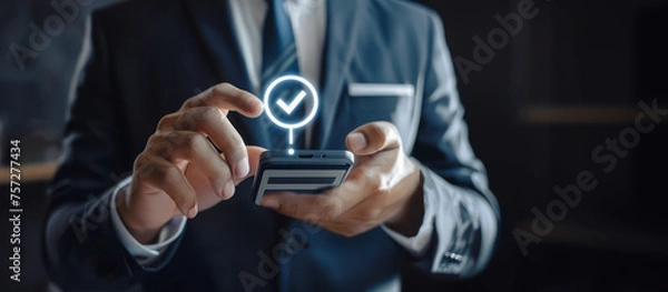 Fototapeta Businessman in suit completes form on smartphone, digital interface boosts efficiency, customer service.