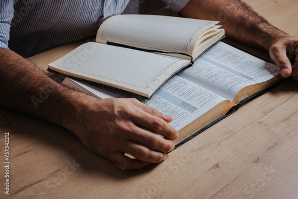 Fototapeta Man is ready to study the Bible and make notes in his notebook