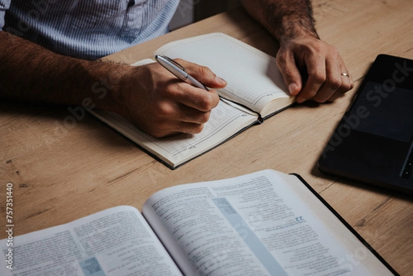 Fototapeta Man is ready to study the Bible and make notes in his notebook