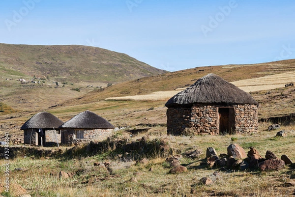 Fototapeta Semonkong, Lesotho - April 22nd 2023 - group of traditional round huts made of stones near Semonkong