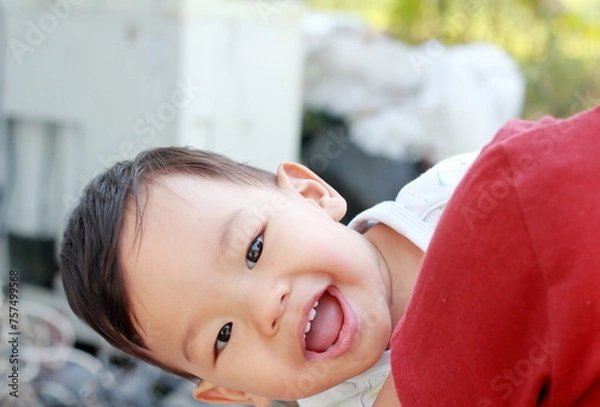 Fototapeta Portrait of a cute boy Cute 2 year old Asian looks cheekily and Teasing with smiling and looking at camera