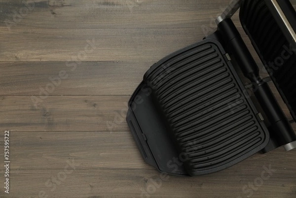 Obraz Electric grill on wooden table, top view. Space for text. Cooking appliance