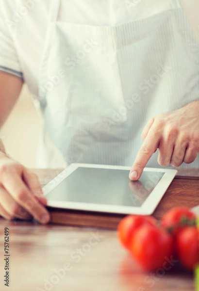 Fototapeta closeup of man pointing finger to tablet pc
