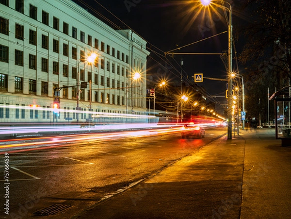 Obraz long exposure tram in a blurry form in the night city center , Moscow, Russia. low light shoot