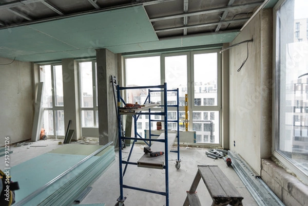 Fototapeta Ceiling installation with expert technicians In the room that is in the construction process.