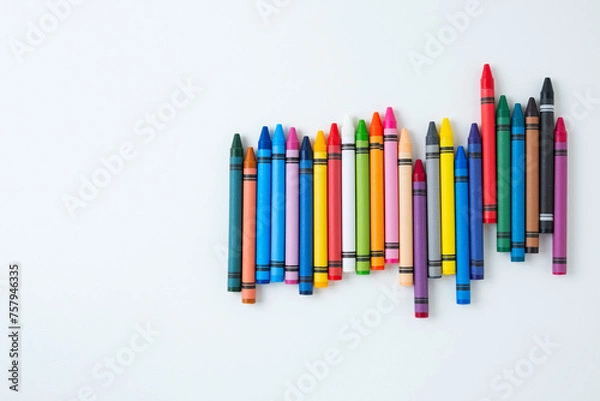 Fototapeta A large set of multi-colored children's wax crayons on a white background.