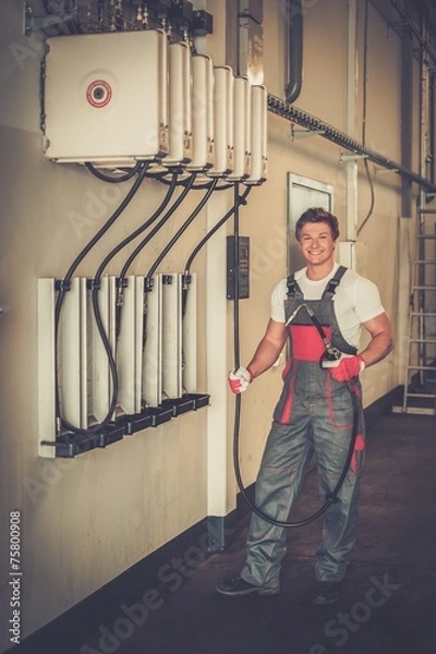Fototapeta Young serviceman  in a workshop