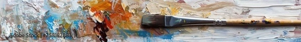 Obraz The artist paints a picture with oil paints on canvas. The artist's brush is dirty with paint. Close-up.