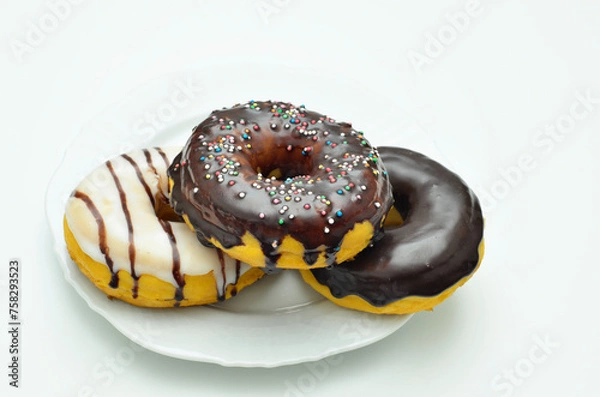 Fototapeta Three assorted Donuts on white Plate