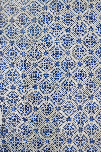 Fototapeta Colorful typical tiles on a wall in Portugal with traditional patterns