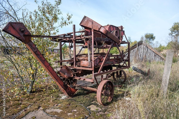 Fototapeta old thrashing machine in kolkhoz near Korohod in Chernobyl Zone