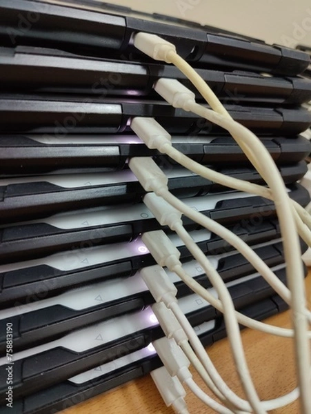 Fototapeta Several tablets on the table in the office on recharging