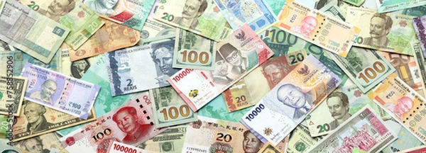 Obraz Many banknotes of different currency. Background of big amount of random money bills close up