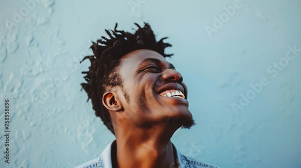 Obraz A man's joyful expression is captured against a cool blue backdrop, highlighting his contagious smile and carefree attitude. The image is a celebration of happiness and positive energy