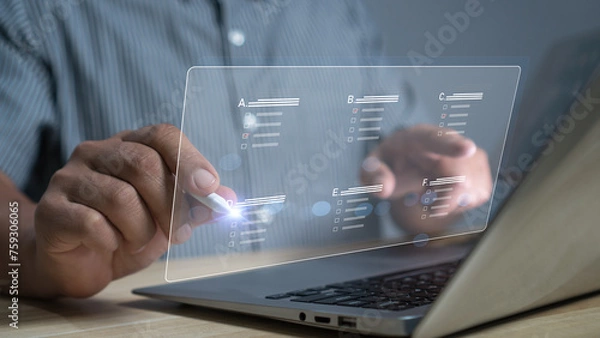 Fototapeta Concept filling out digital form checklist, take an assessment, questionnaire, evaluation, online survey, exam. Businessman Hand using stylus pen performance checklis laptop online checklist survey.