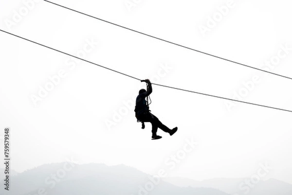 Obraz Silhouette of the person on the zip line in the sky