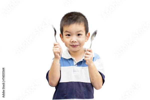 Fototapeta Little handsome Asian boy portrait holding spoon and fork with smiling face isolated on white background