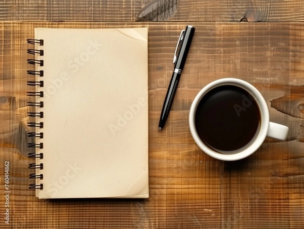 Obraz An empty notebook with a pen on a wooden surface next to a cup of black coffee.