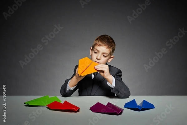 Obraz Boy in suit making yellow paper plane