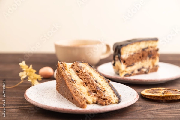 Fototapeta Chocolate biscuit cake with caramel cream on brown wooden. side view, selective focus