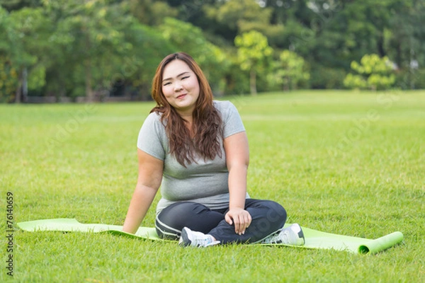 Obraz beautiful obese women sitting on grass.