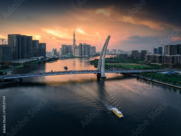 Fototapeta 
Brilliant sunset afternoon on the tallest building in Vietnam. Below is the Saigon river and the boat is running. Photo taken in June 2023