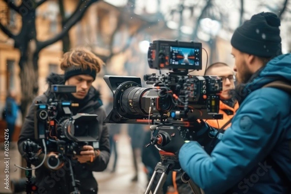 Fototapeta A group of people standing around a camera. Suitable for business or team collaboration concepts